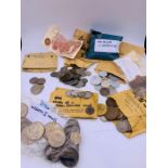 A selection of coins and banknotes to include UK and International.