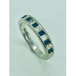 An 18 ct white gold half eternity ring with diamonds and sapphires.