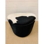 A faux cowhide foot stool