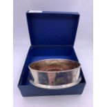 A hallmarked silver, engraved, wine coaster, boxed.
