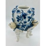 A Meissen vase on three feet with cherub design.