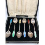 A boxed set of silver and enamel spoons in an Art Deco style, makers mark HCD and hallmarked