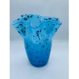A decorative blue glazed vase with flared rim