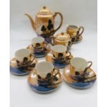 A Japanese set comprising coffee or tea pot, sugar bowl, milk jug, six saucers and five cups (1AF)