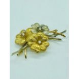 A vintage Cartier 18 ct gold and diamond brooch in flower form