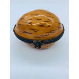 A Limoges porcelain pill box in the form of a walnut.
