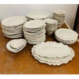 A selection of white glazed pottery tableware stamped MUD, to include twelve large dinner plates and