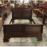 A large mahogany sleigh bed with ridged detailing to both ends to fit a five foot mattress with