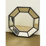 A large octagonal contemporary mirror containing eight outer bevelled mirror and a central