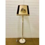 An ivory painted wooden floor lamp with Edinburgh themed velvet lamp shade