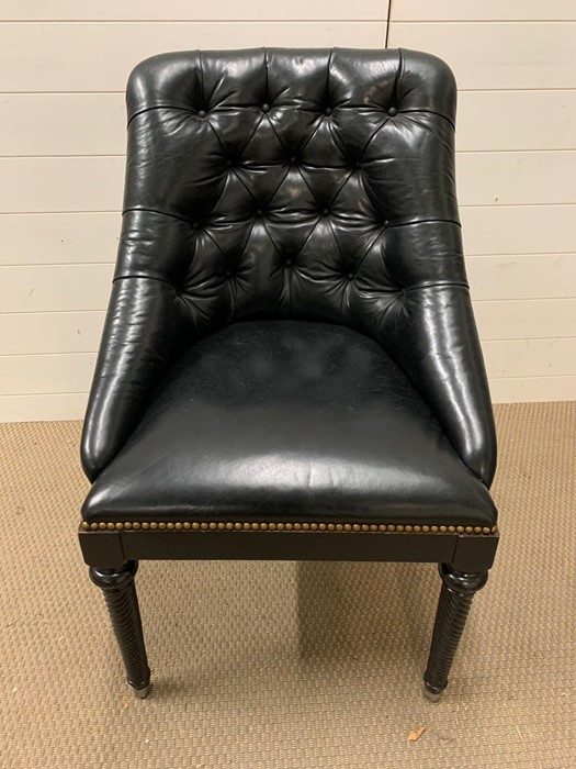 A leather button back club chair