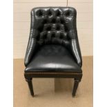 A leather button back club chair