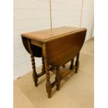 A gate leg dinning table on barley twist legs