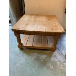 A low pine square small coffee table with lower shelf