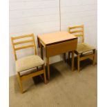 A modern gateleg table with two matching chairs in a pale oak veneer