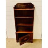 An open inlay bookcase with cupboard under