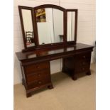 A mahogany dressing table with drawers to side and a triple mirror