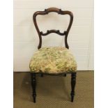 A Victorian mahogany chair with shaped balloon back scrolled middle rail, fluted baluster front legs