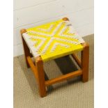 A small footstool with a woven top