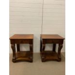 A pair of solid wood bedside tables with drawer to centre