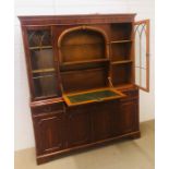 A large yew effect drinks display cabinet with internal lighting and original key