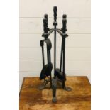 A wrought iron fireside companion set