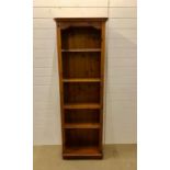 A narrow pine bookcase