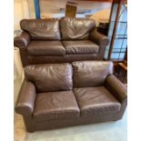 A pair of brown leather two seater sofas