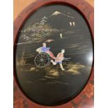 A mother of pearl inlaid oriental scene in a lacquered oval frame