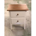 A small cream painted oak topped bedside cabinet