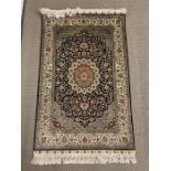 A pure silk rug of unusual design 77cm x 121cm