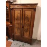 An attractive wardrobe with burr walnut panelled front, reeded sides sitting on bun feet with an
