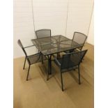 A modern grey aluminium outside garden table with four matching chairs