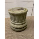 A small stone pillar seat