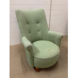 A mid century button back upholstered chair with great design