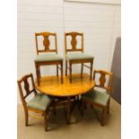 Round gateleg pine table with four chairs