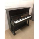 A striking small upright piano in a dark brown gloss wood made by Hicks of New Kent Road (H117cm