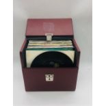 A selection of 45's in a red vinyl box case to include The Beatles, Michael Jackson, Manchester