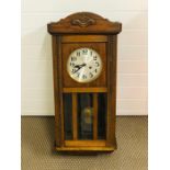 A wooden cased wall clock