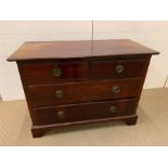 A chest of drawers two over two with foliate brass handles