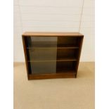 A mid century glazed bookcase by Gibbs & Co (H84cm W91cm D24cm)