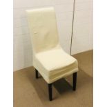 A modern chair in cream with a cream linen chair cover