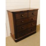 An impressive mahogany two over three chest of drawers on bun feet with bun handles