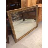 A large modern gilt framed bevelled mirror (136cm x 107cm)