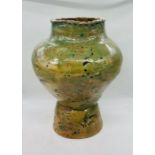 A large Studio Pottery vase, mainly green with a floral decoration signed totue base,"Maura"
