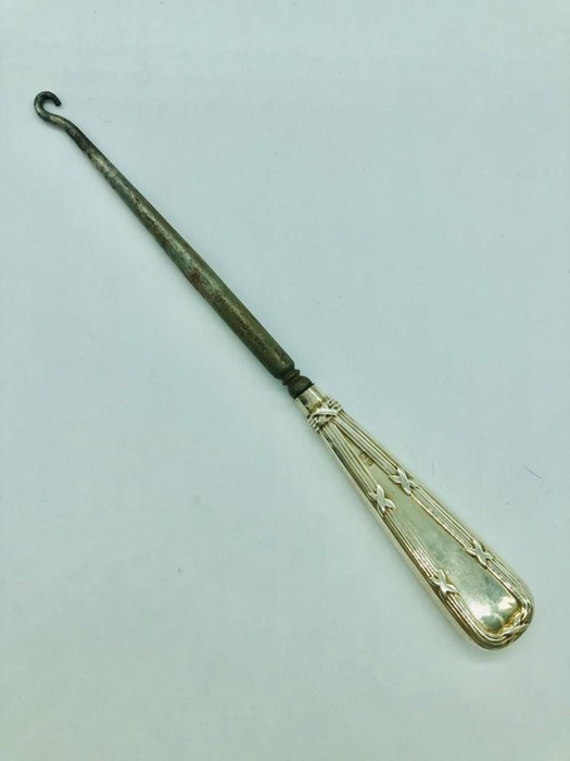 A Silver handled glove pull.