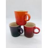 Three Le Creuset coffee cans in volcanic, cense and fig