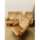 A mid-century two seater sofa and two armchairs