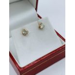 A pair of 1/4 ct diamond stud earrings