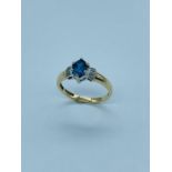 9ct yellow Gold ring set with approx 5.75mm x 4.15mm Marquess cut Blue Topaz with Diamonds to